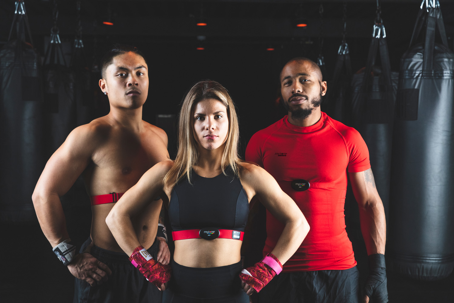 Three people in gym wearing Myzone fitness trackers